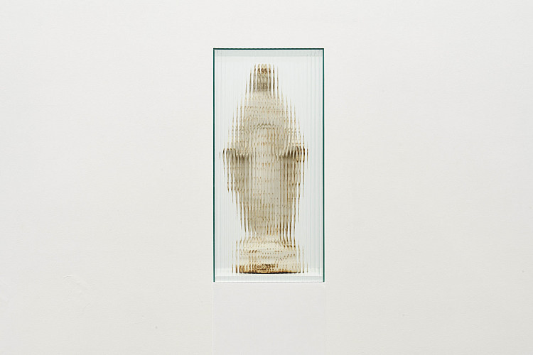 Gallery image: This is where I leave you (Madonna of the suffering. The origin of the universe) | 2020 | A rusted, wrought-iron found statue of the Madonna is encased in a vitrine made of fluted glass | Inspired by the 1686 shipwreck of the Nossa Senhora dos Milagros along the treacherous Cape Agulhas coast, the artist collected a series of found objects to serve as placeholders in a retelling of the story.