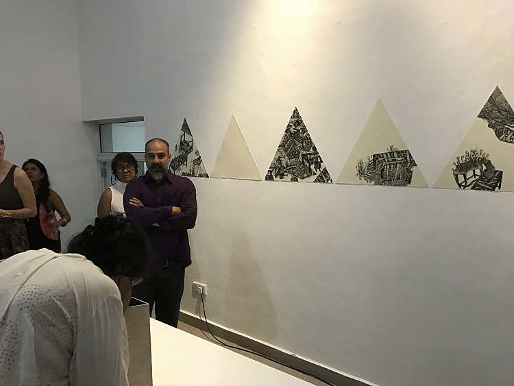 Gallery image: Endless Space | 2016 | installation with kaleidoscopes nd mixed media | measurements variable | I placed triangular kaleidoscopes before triangular drawings to evoke the feeling of endless triangular space, where triangles symbolized law, equality, and religion. In this space, I illustrate the dark and violent past.